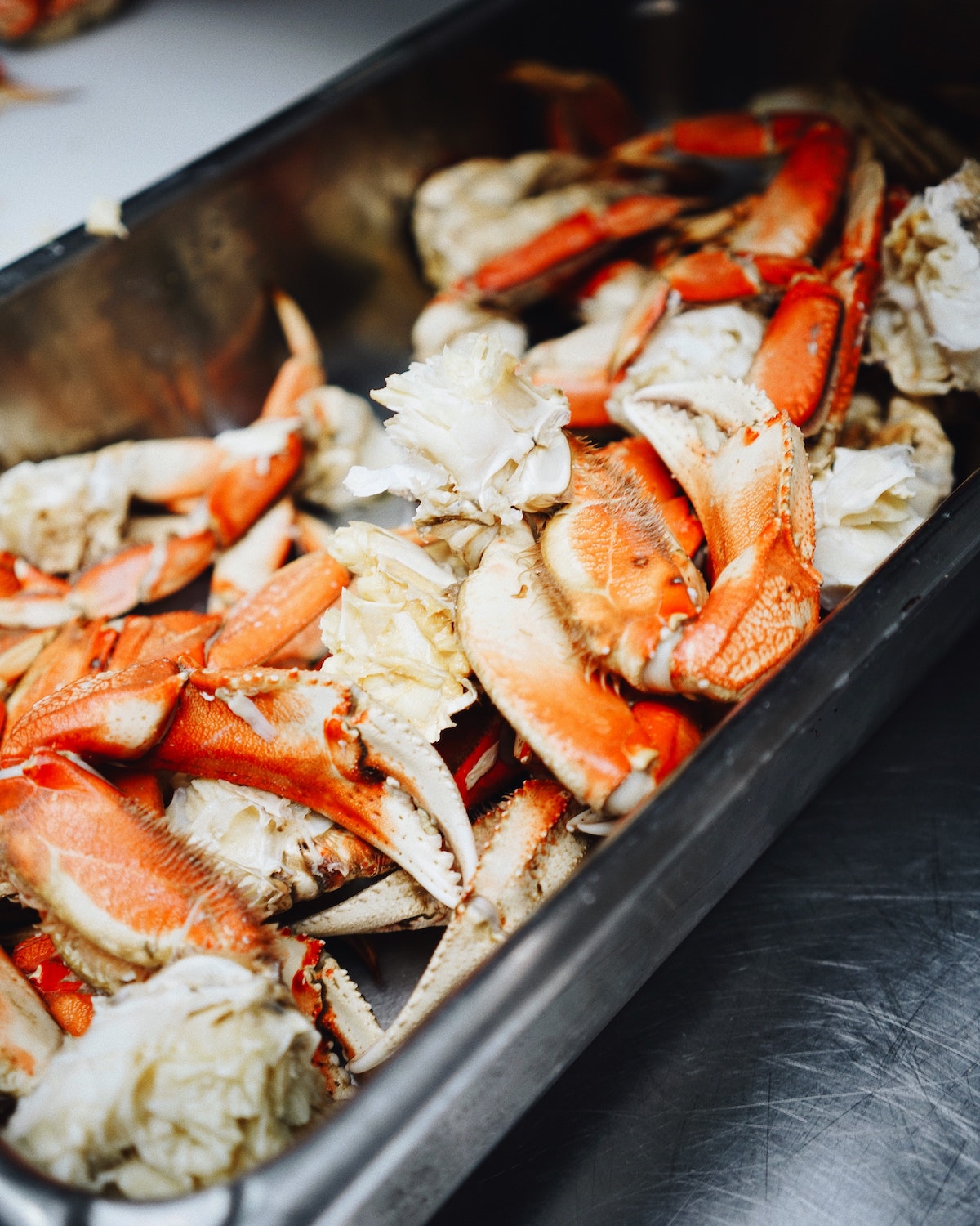 Extreme close up of a baking tray with cooked crab.