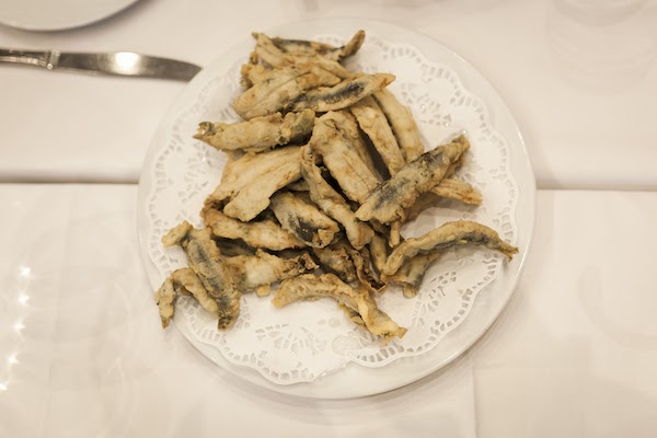 Plate of fried anchovies on a table