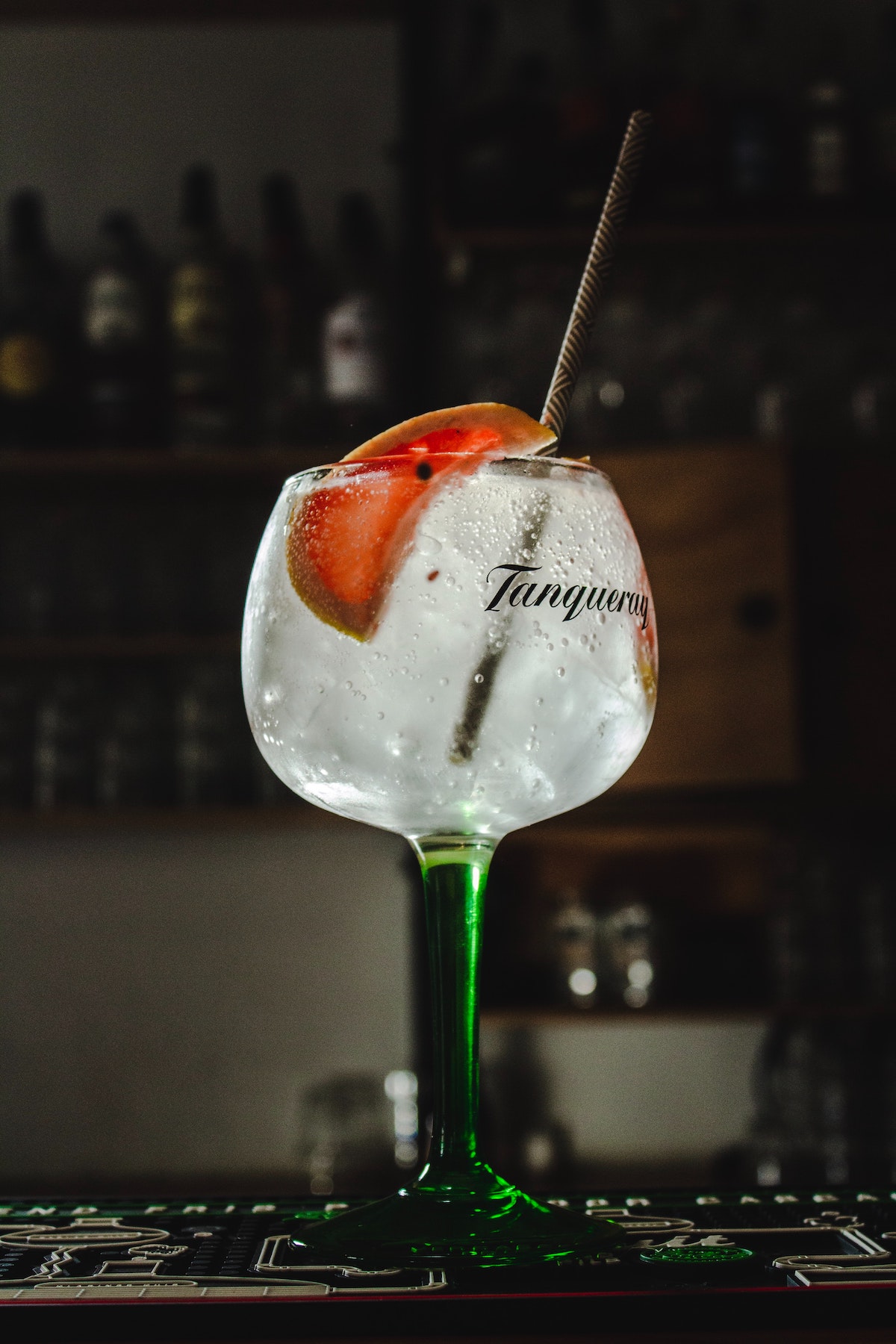 Gin and tonic garnished with citrus in a long-stem glass