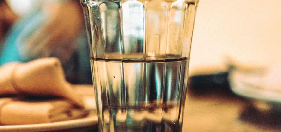 Clear glass of water on a wooden table