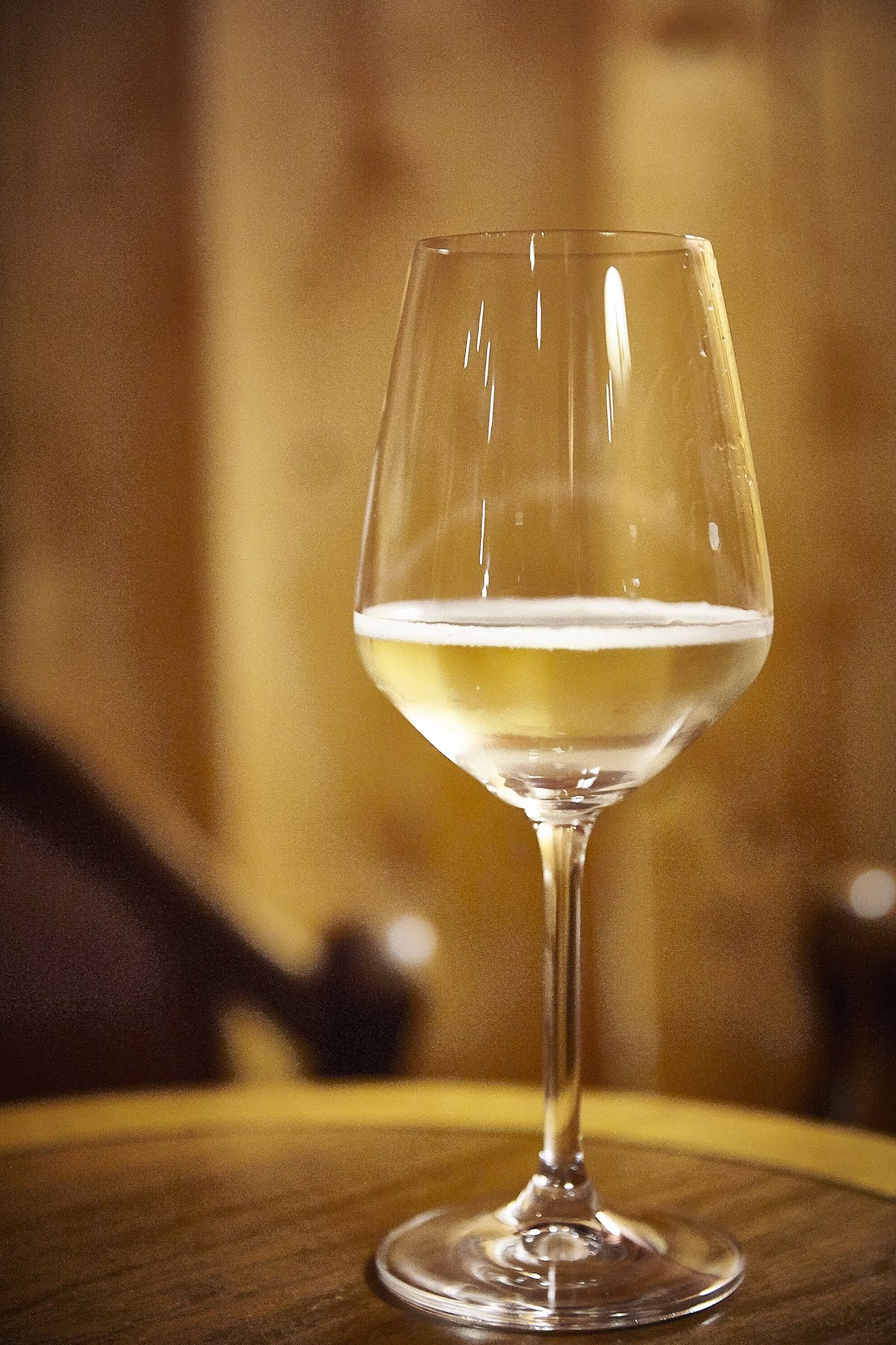 Glass of white wine on a wooden surface