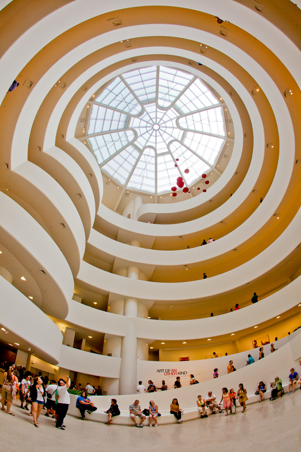 Large glass dome at the Guggenheim Museum in NYC with spiraled walkways beneath to lead people past the art on display