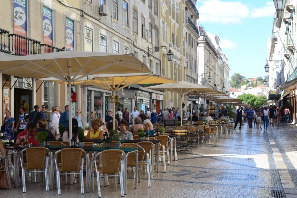 Customers sitting outside cafes at Rua Augusta in the Baixa neighborhood, where some of the most fascinating Roman ruins in Lisbon have been found.