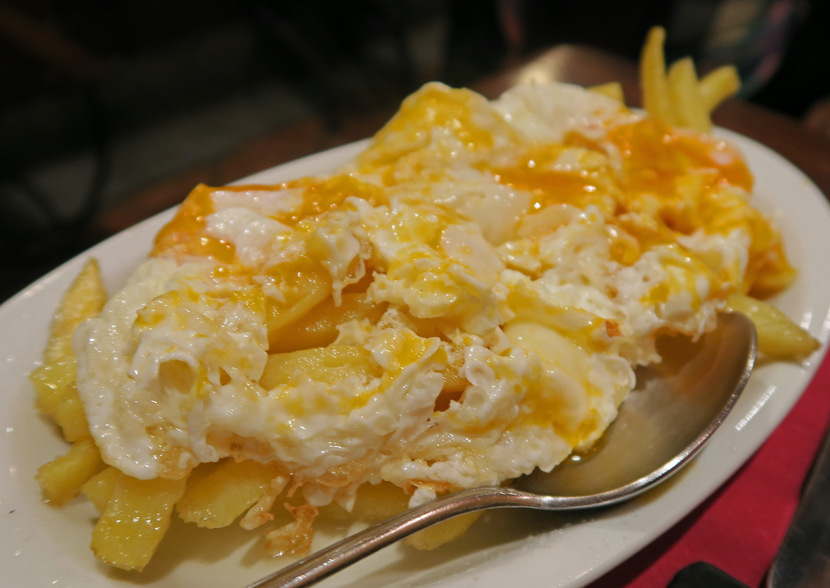 Plate of an egg and potato dish at a Madrid tapas bar.