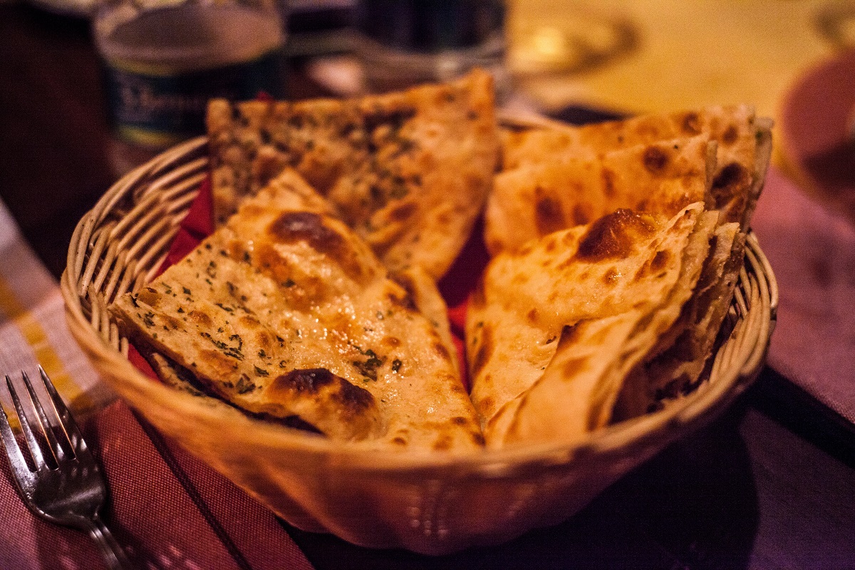 Naan in a wicket basket on a table