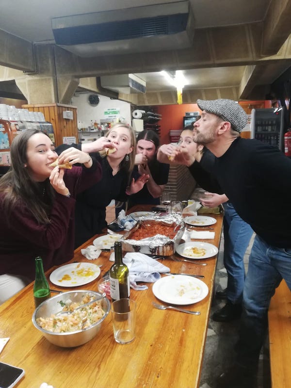 Devour San Sebastian guides eating dinner inside a Basque gastronomic society