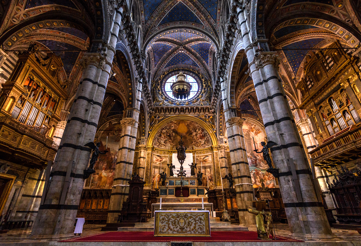Interior of Gothic cathedral with religious paintings and intricate details