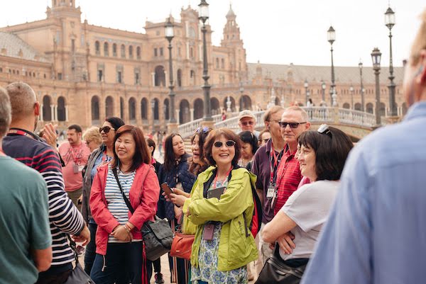Tourists in Seville's Plaza de España