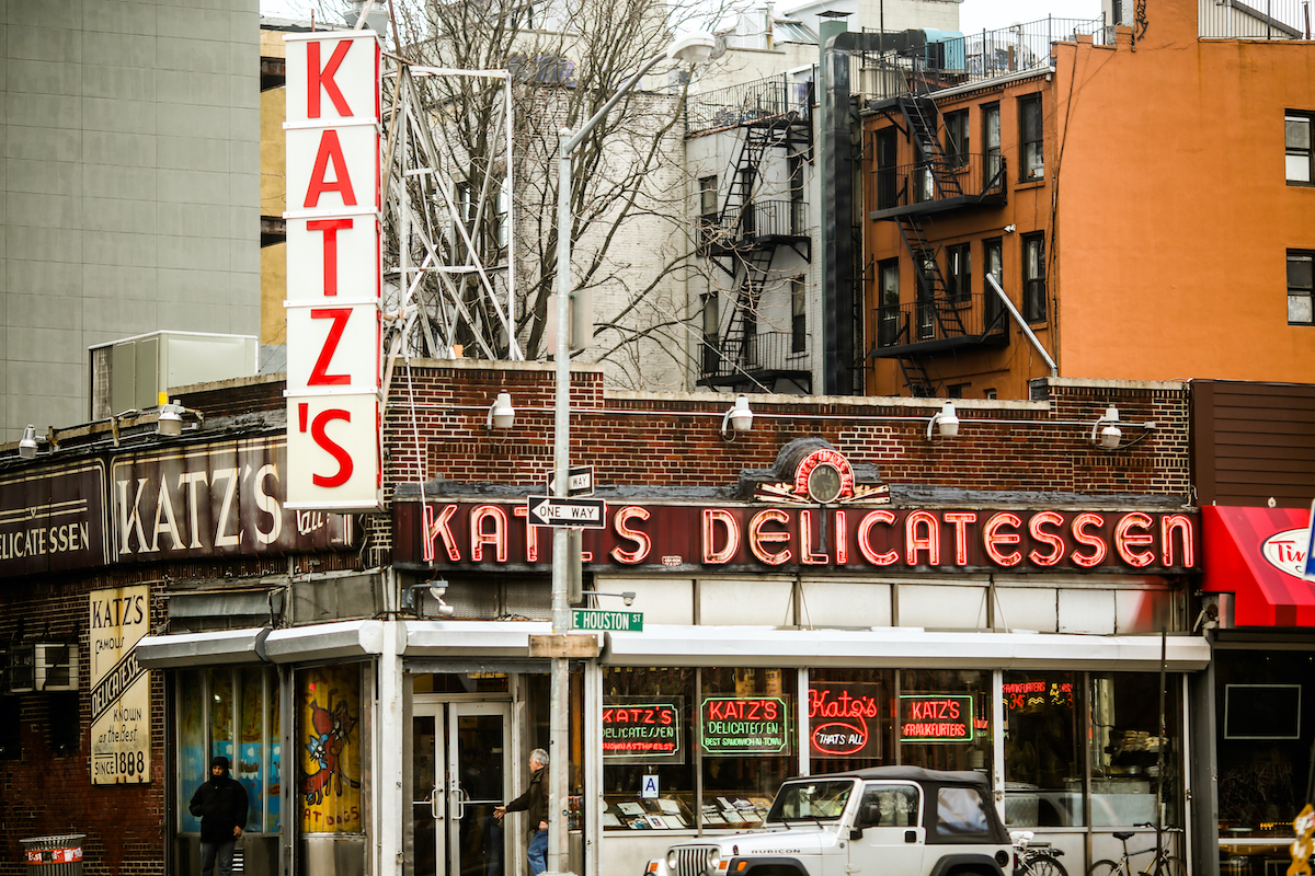 Exterior of Katz's Deli on NYC's Lower East Side, with a large vertical sign bearing the business's name