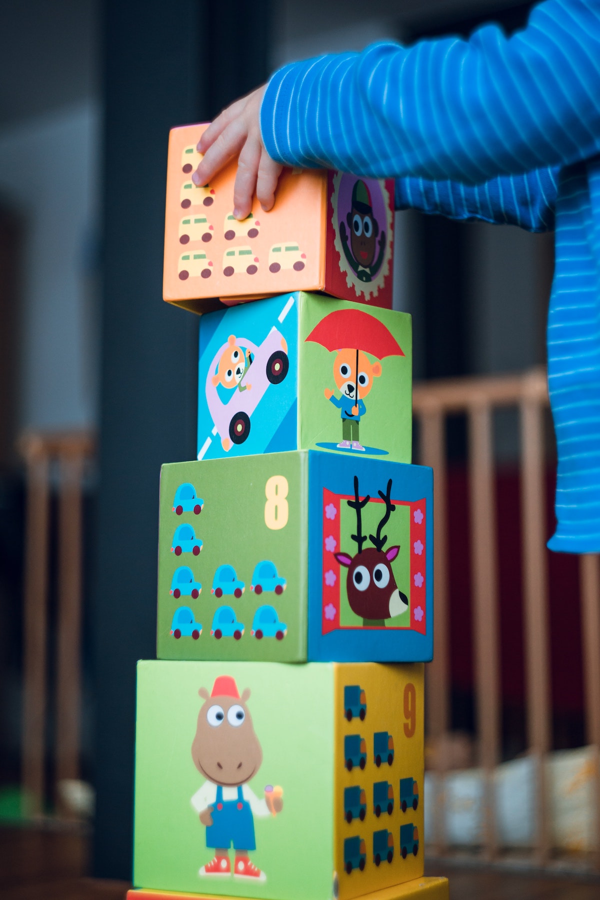 A child stacking large colorful blocks