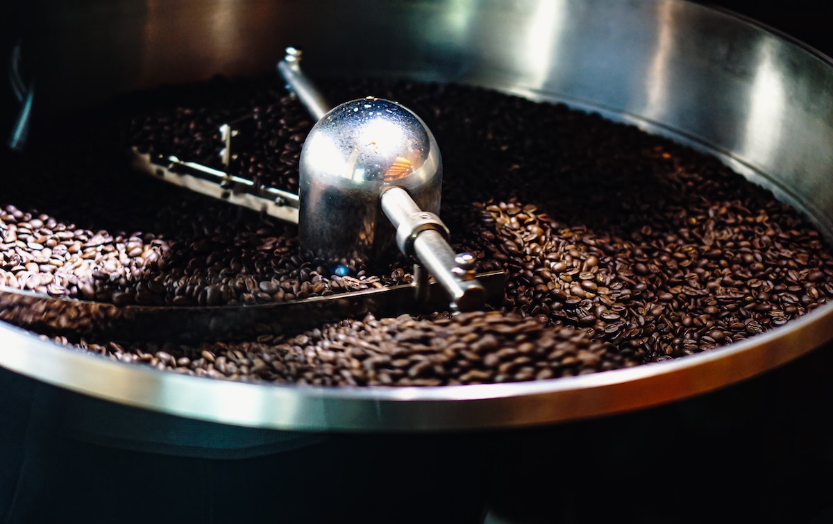 close up of a coffee beans in a roasting machine
