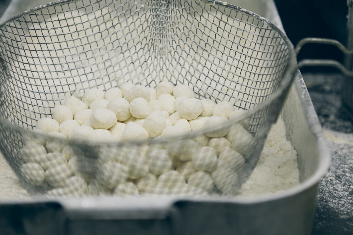 Balls of buffalo mozzarella in a wire seive