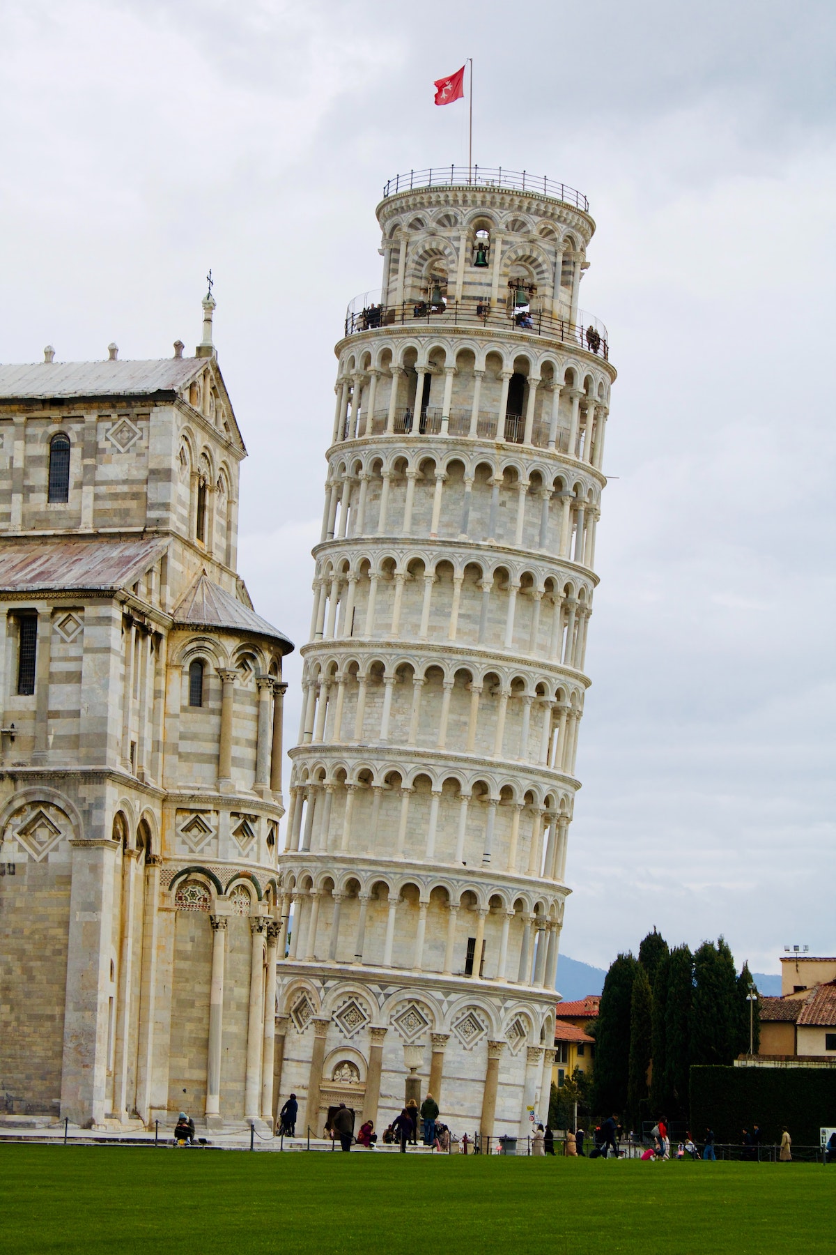 Tall white leaning tower on a cloudy day