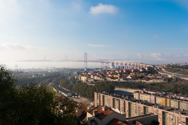 View of bridge 25 de Abril from Cemitério dos Prazeres in Lisbon off the beaten path.