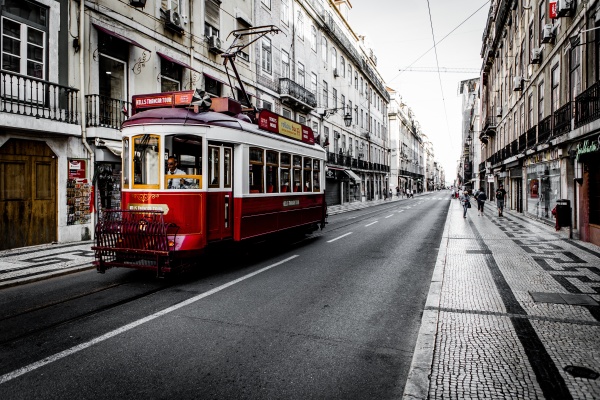 Red tram on rails in Lisbon - guide to Lisbon Tram 28