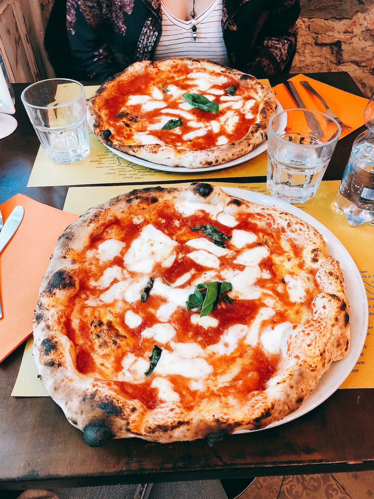 Two margherita pizzas on a restaurant table