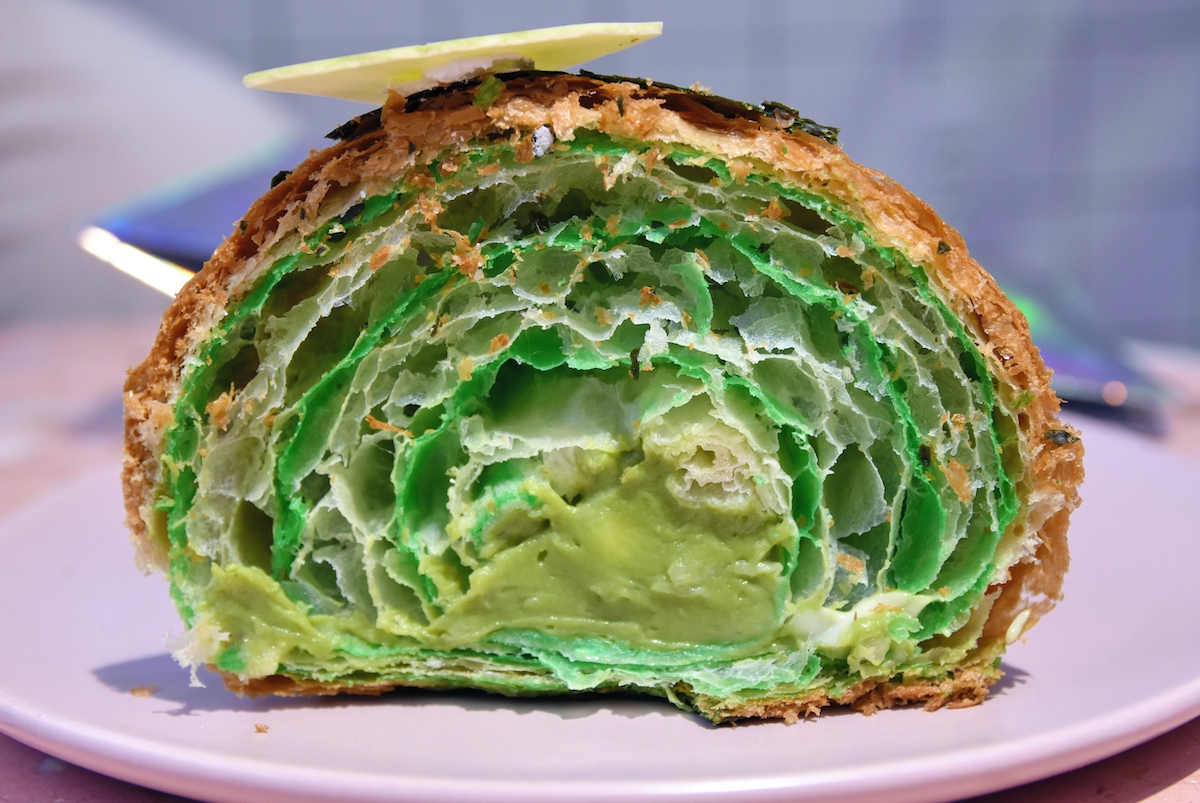 Cross section of a croissant stuffed with a green cream