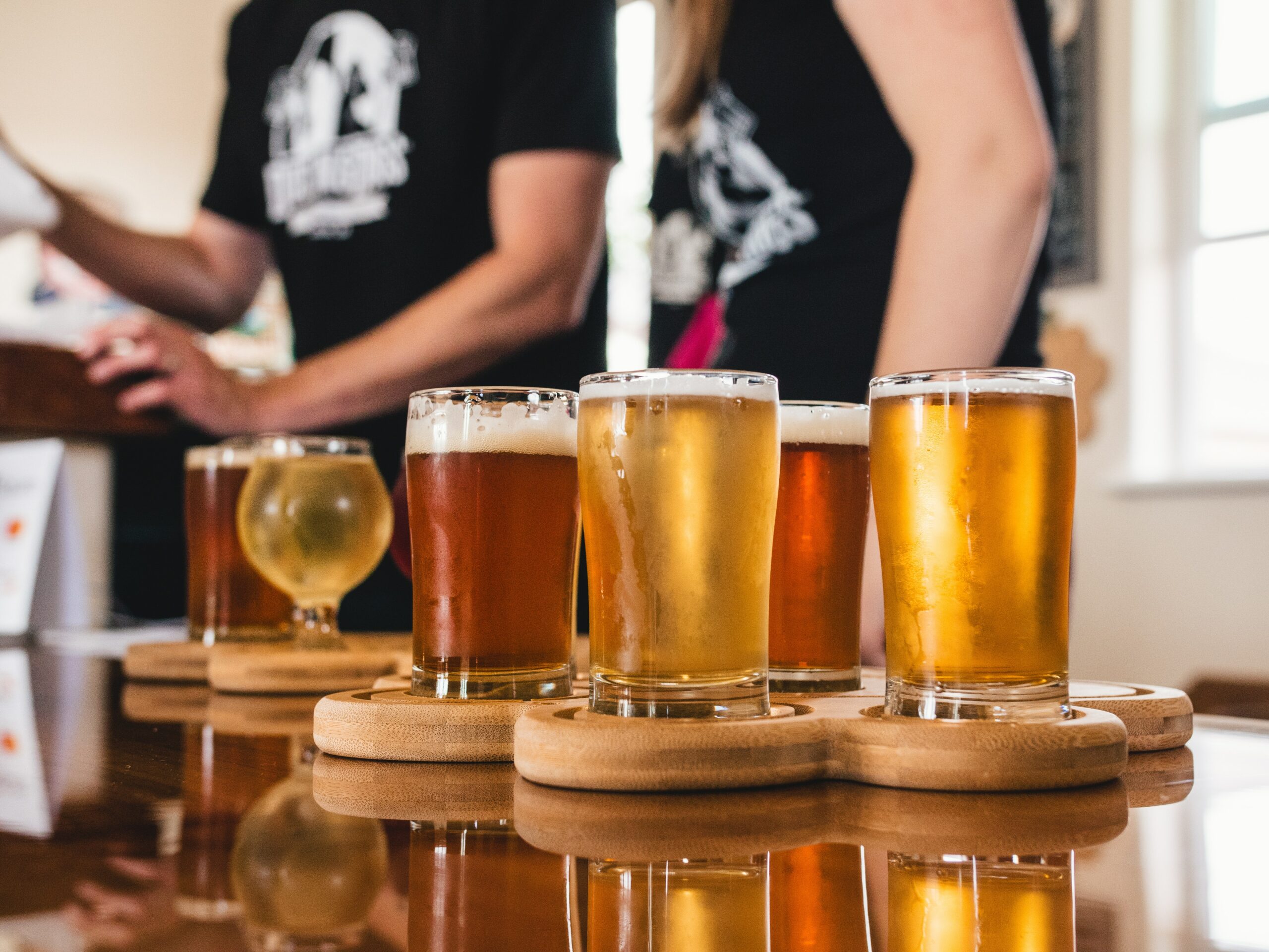 A bunch of glasses filled with different craft beers