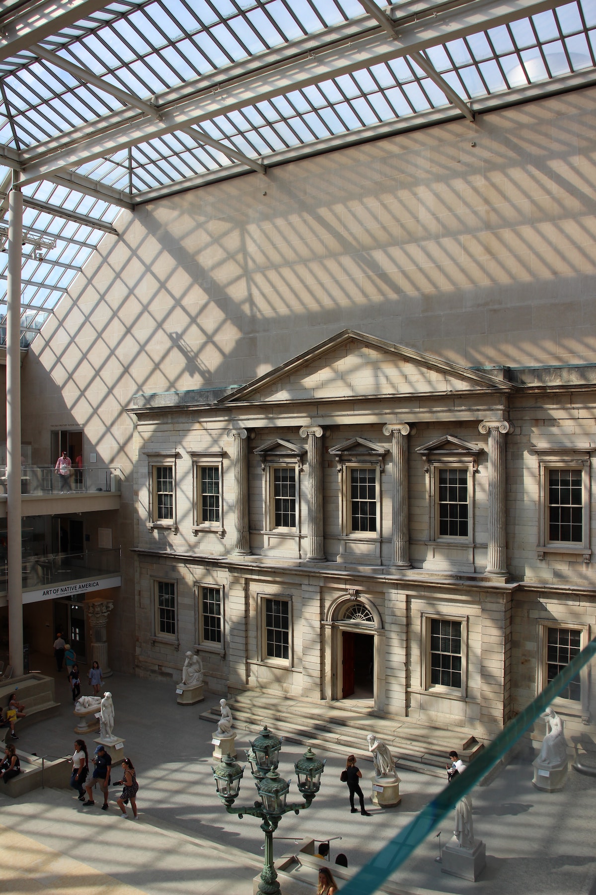 Museum interior with high, windowed ceilings and light streaming in through the slats
