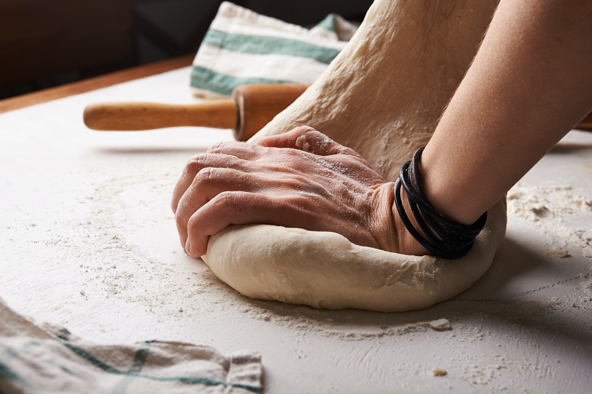 Baker kneading bread dough