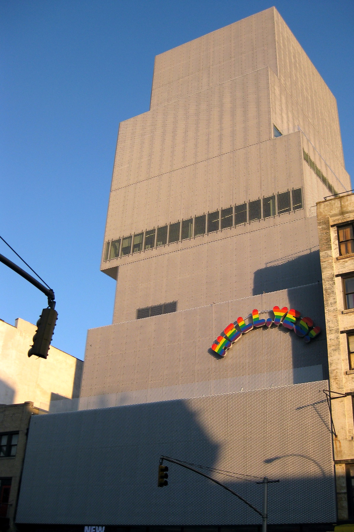 Contemporary gray building with rainbow letters reading "Hell Yes" on the right-hand side