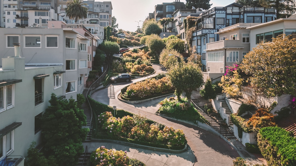 View of Lombard Street in San Francisco, with its many hairpin turns and residential buildings on either side