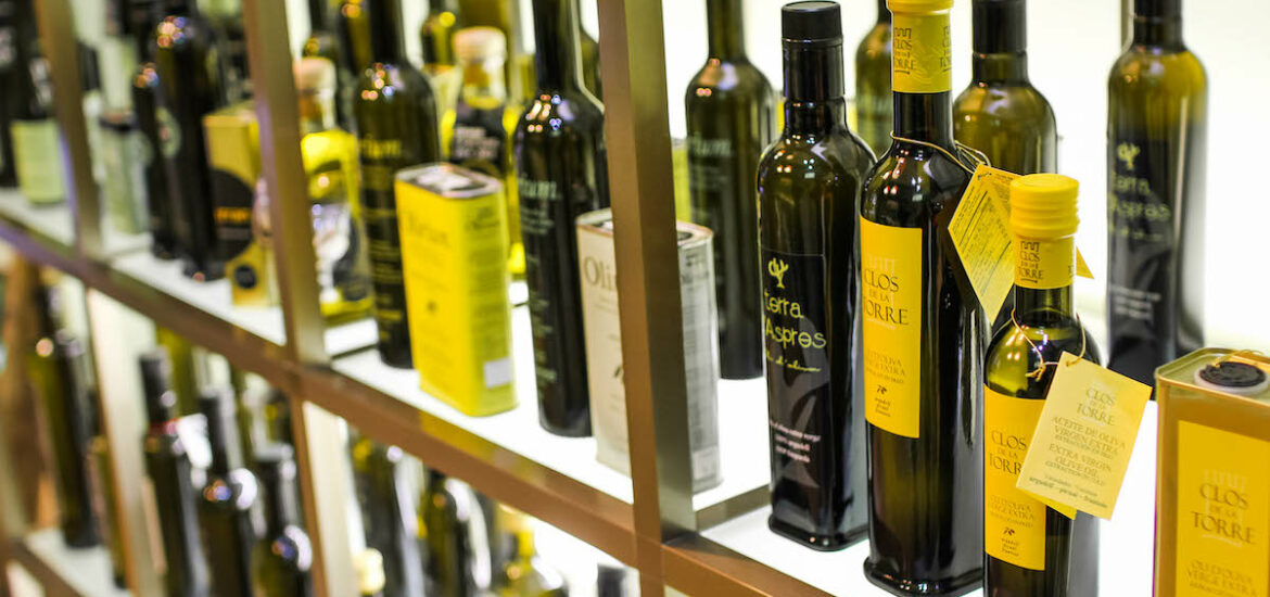 Bottles of olive oil on display at a shop.