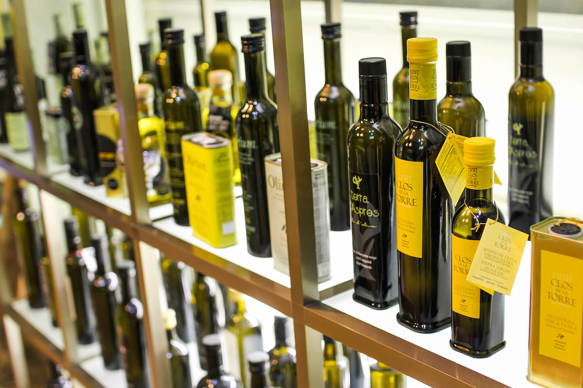 Bottles of olive oil on display at a shop.
