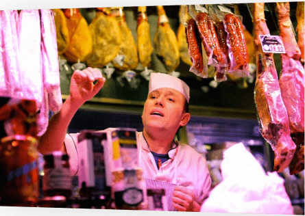 Butcher behind selection of meats