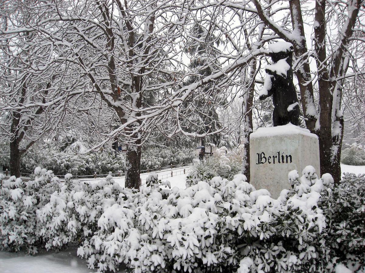 Statue of a bear representing the city of Berlin in a park in Madrid after a snowfall.