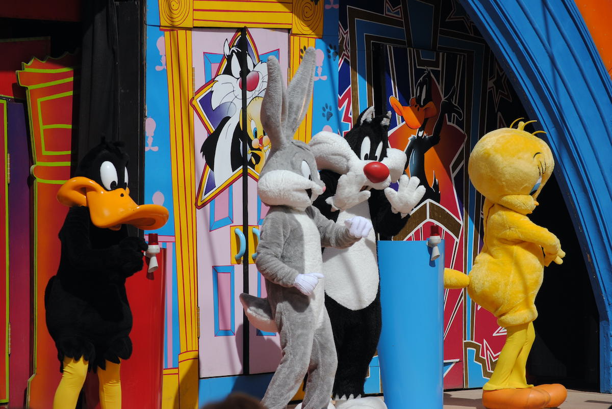 Costumed performers dressed up as Daffy Duck, Bugs Bunny, Sylvester the Cat, and Tweety Bird