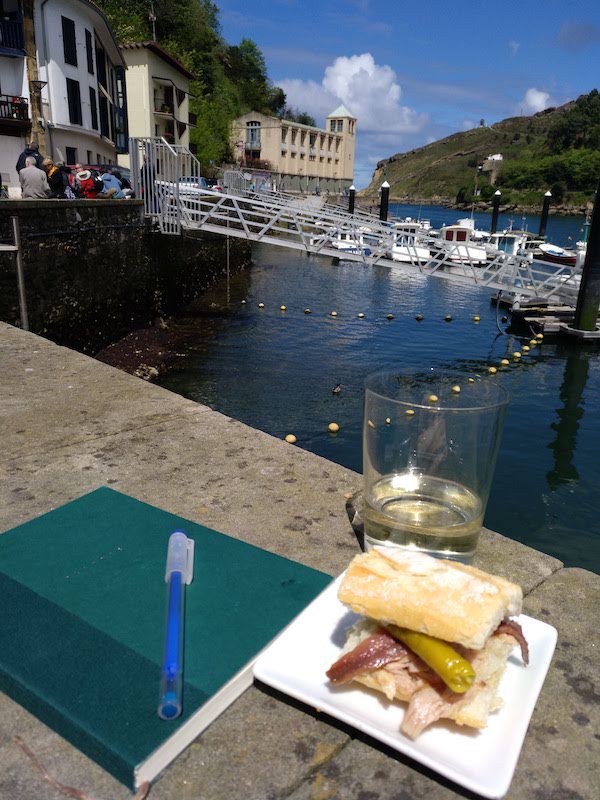 Pintxos and txakoli (Basque white wine) on a terrace overlooking the water