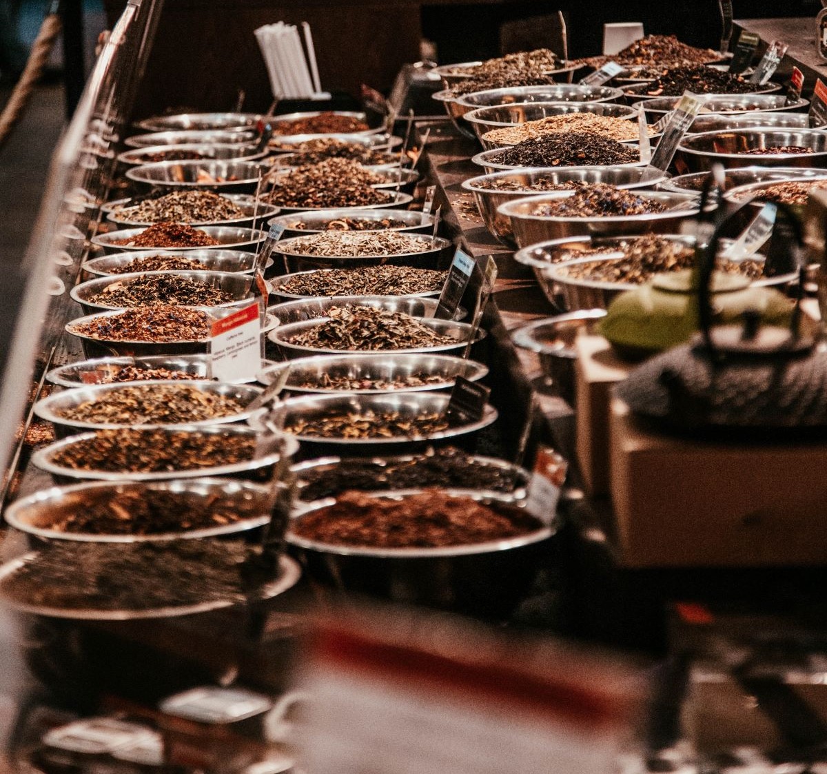market stand with different spices in silver bowls