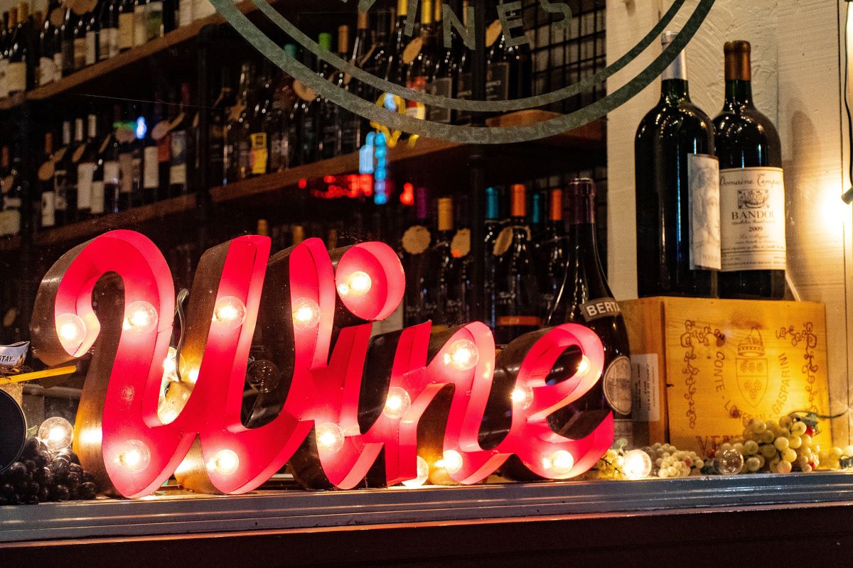 red wine sign and wine bottles