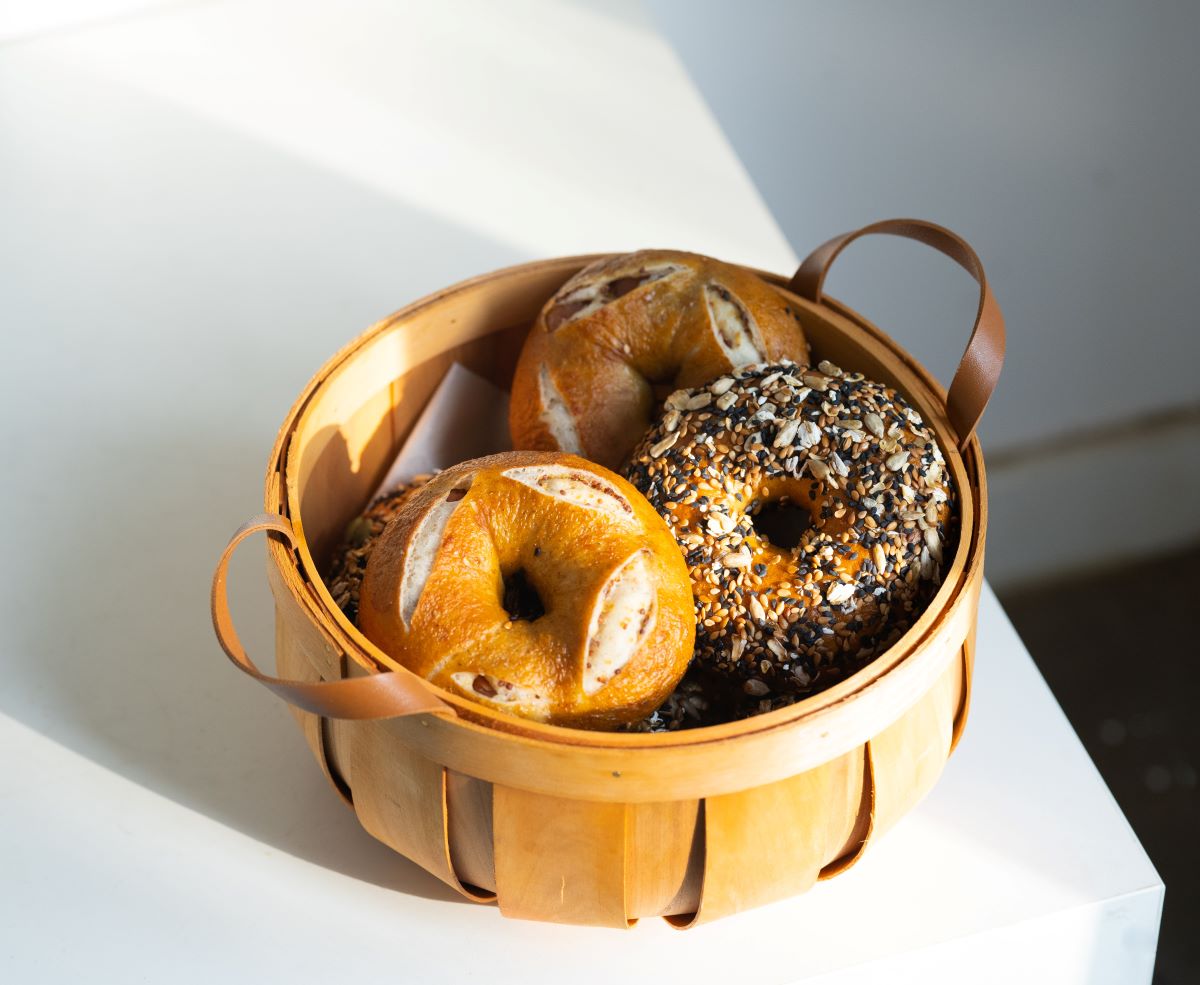 bagels in basket on white table