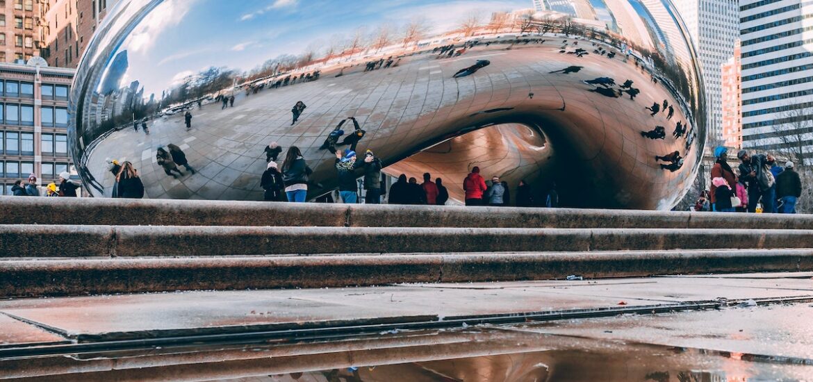 A blue sky reflects off of the Chicago Bean