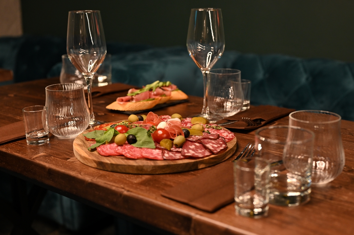 charcuterie board and glasses on a wooden table