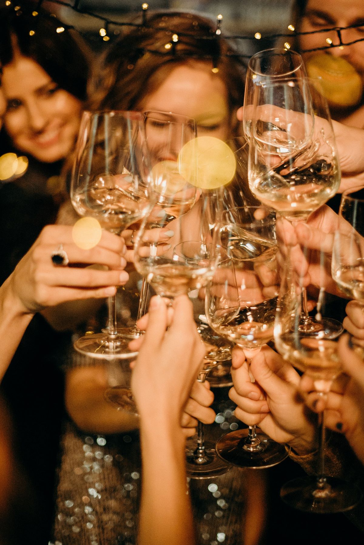 people cheering with wine glasses