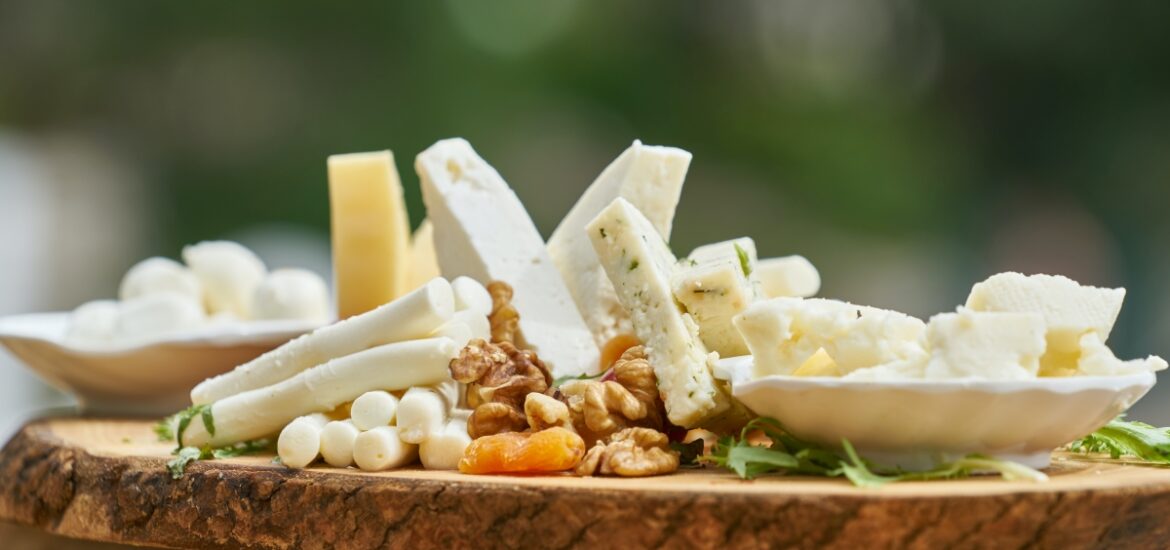 various cheeses on wooden board