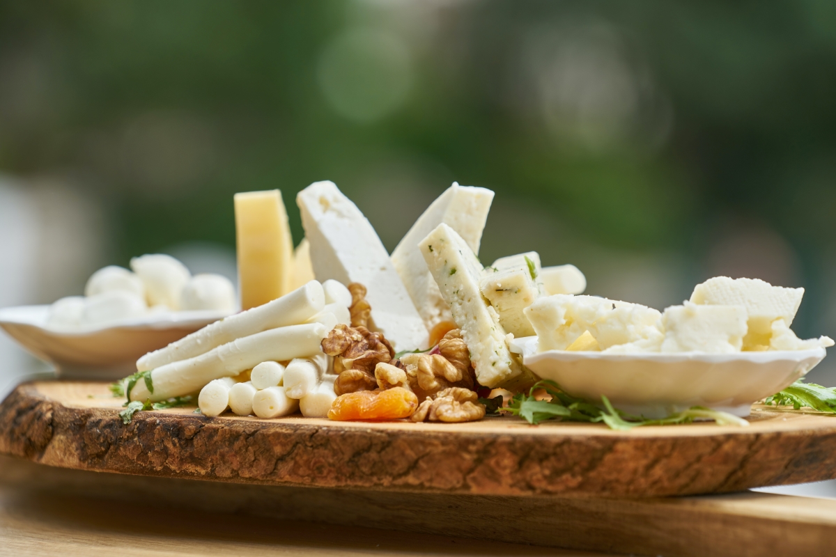 various cheeses on wooden board