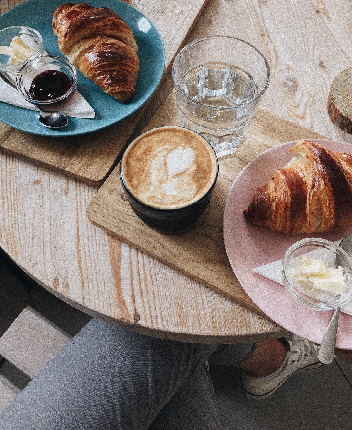 Breakfast trays of coffee and croisant at an indoor table