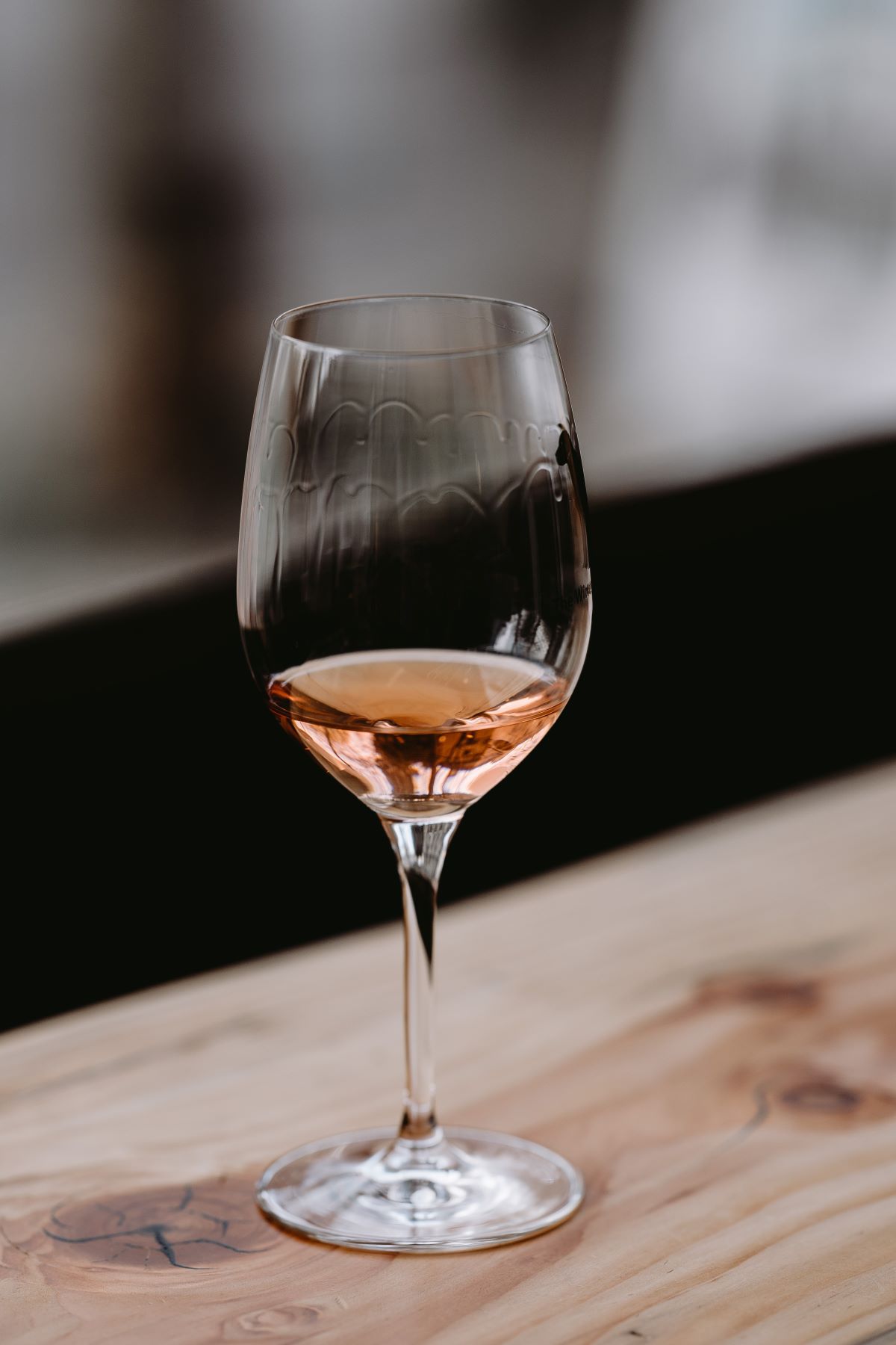 glass of rose wine on wood shelf