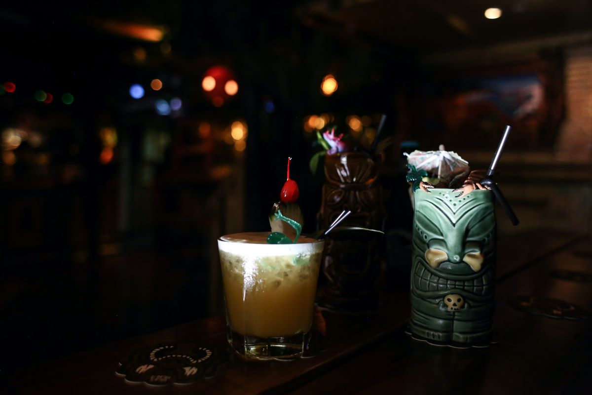 tiki cocktail in darkly lit bar