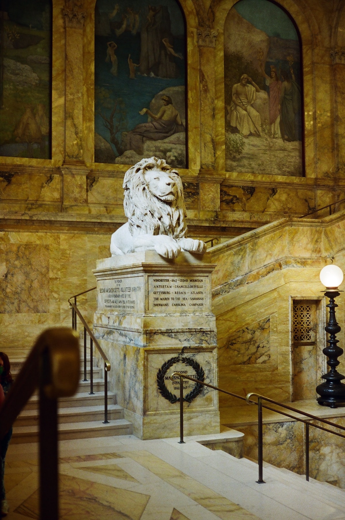 lion statue at the grand staircase of Boston public library
