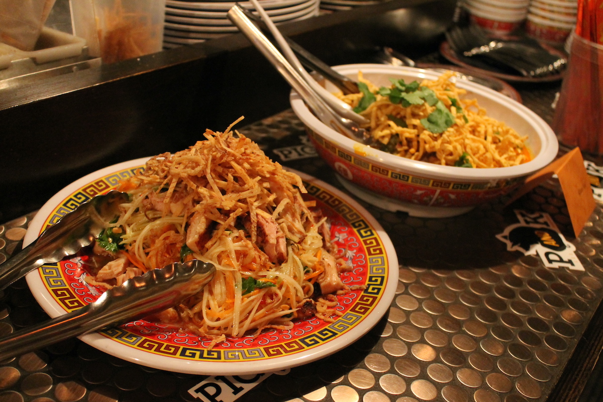 Two Asian noodle dishes served in bowls