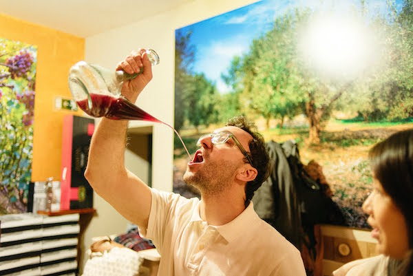 One unique experience in our wine lover's guide to Barcelona: drinking from the porrón!