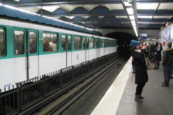 Passengers on a metro station platform in Paris