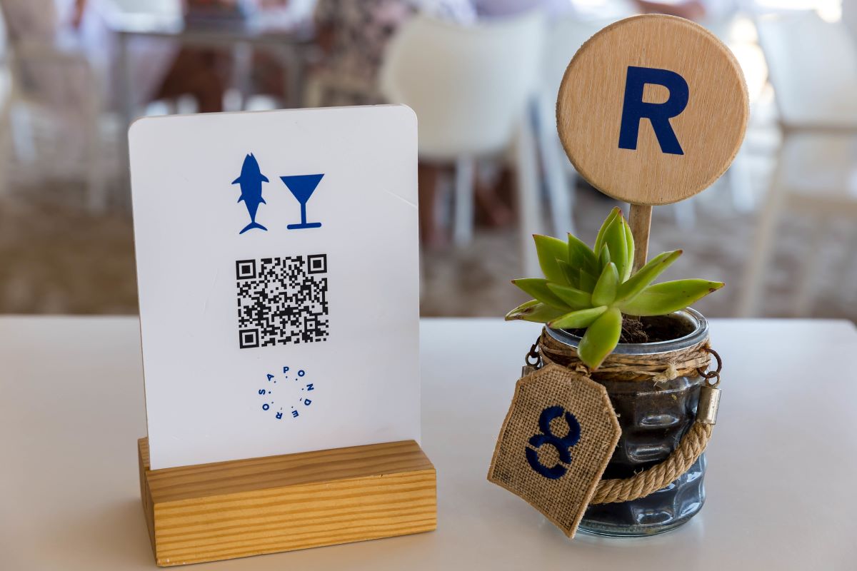 table with qr menu stand and plant
