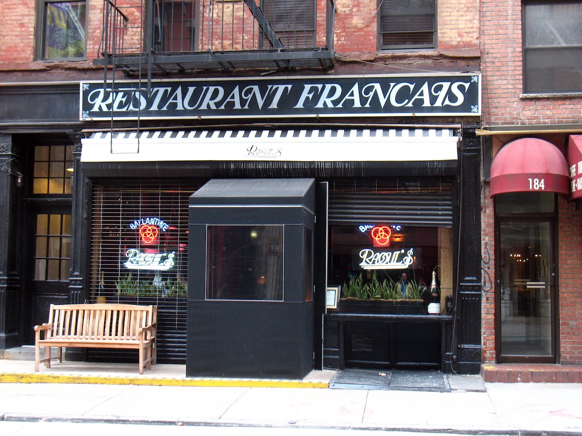 Exterior of Raoul's restaurant in SoHo, NYC, with a large black and white sign reading Restaurant Francais
