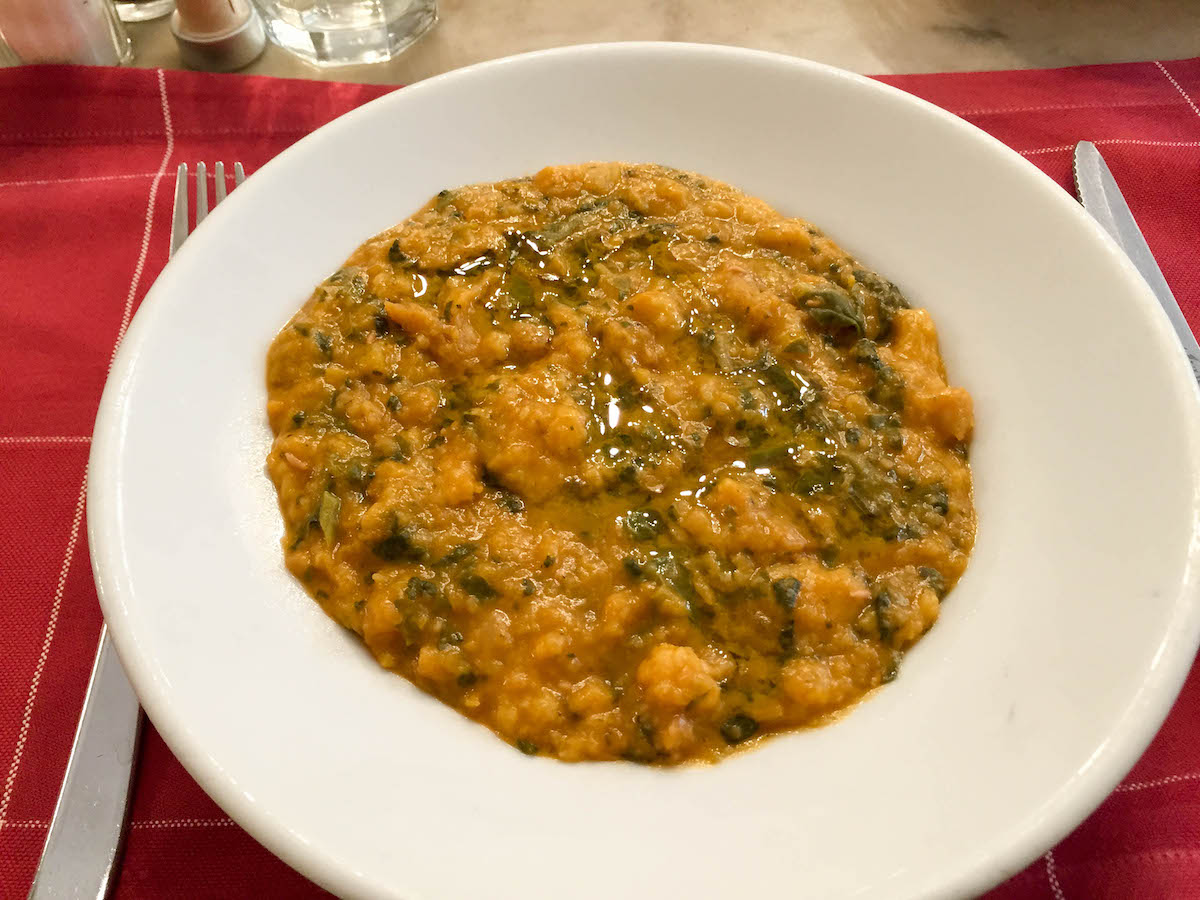 Typical Tuscan bread and kale soup in a white bowl